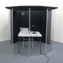 IsoPac I translation and podcasting isolation booth with a table, chair, laptop, and microphone inside